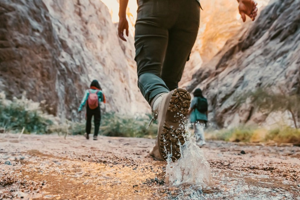 Three hikers walking in nature representing Squirrel's Nut Butter all-natural salve that prevents chafing and blisters in desert heat and mountain conditions